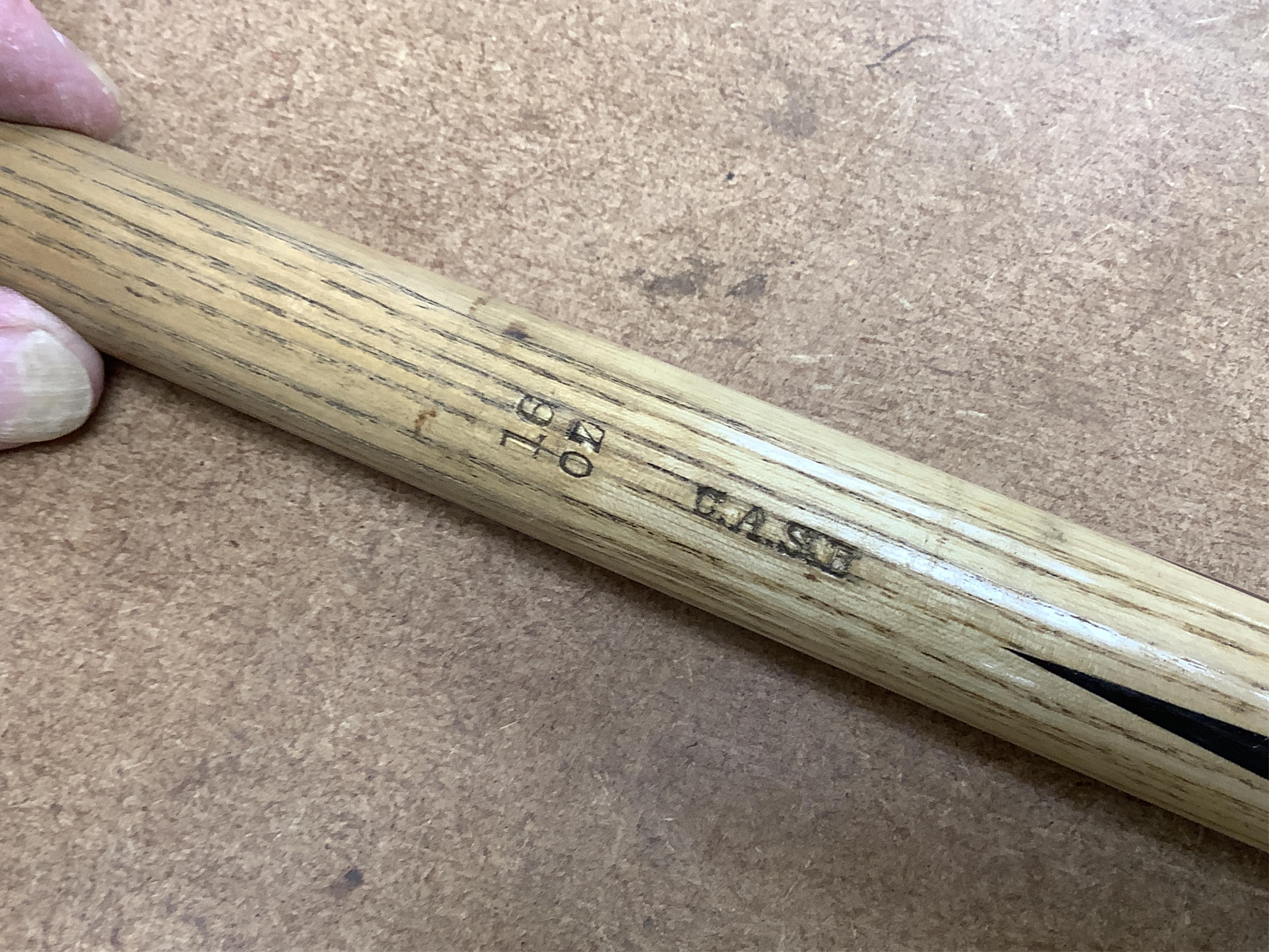 A collection of tribal spears, a fish hook, a cased snooker cue, etc.